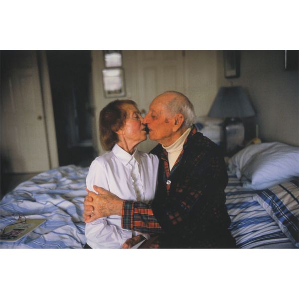 My parents kissing on her bed